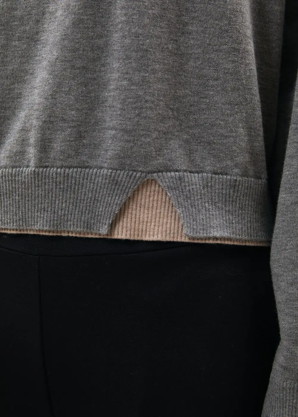 Humility knit hem detail with contrast under-layer