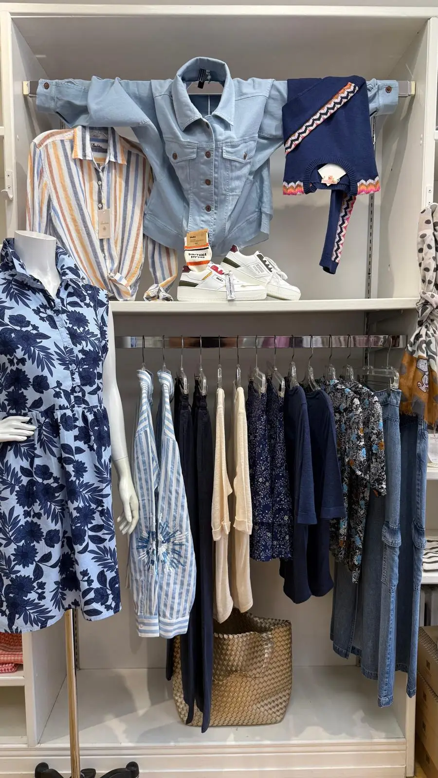 A display inside Cornflower Blue with printed dresses, denim and knits in blues